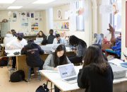 A group of diverse students studying and collaborating in a vibrant and creative classroom setting.