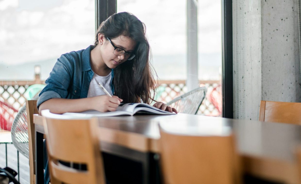 woman writing on book
