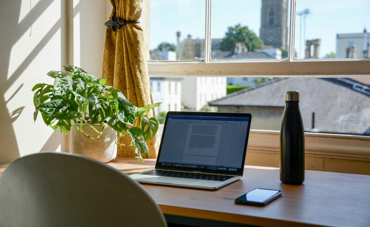 macbook pro on brown wooden table