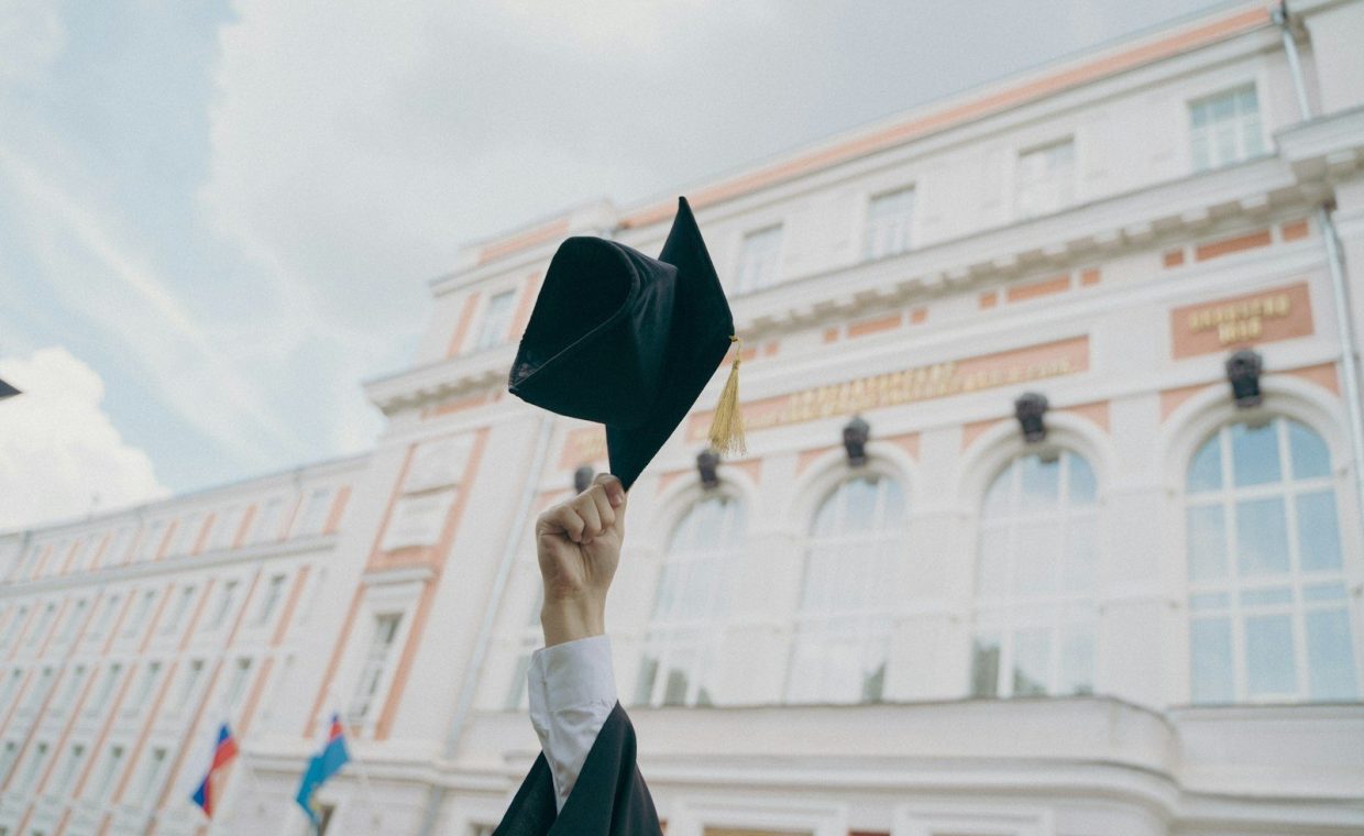 a person holding a black umbrella